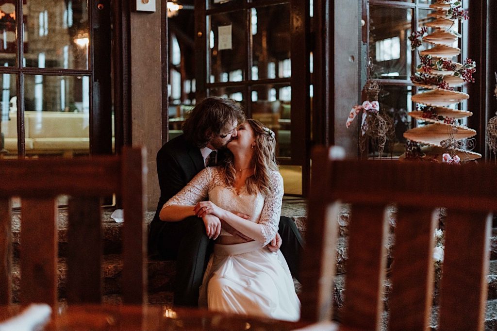 A bride and groom share a drink at the bar at their cabin at Starved Rock National Park.