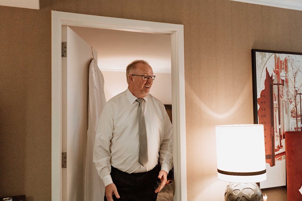 The father of the bride sees his daughter for the first time on her wedding day.