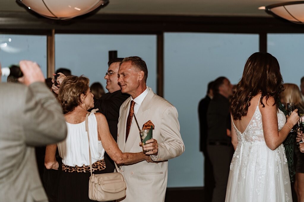 Guests dancing on the 95th floor signature room during a wedding.