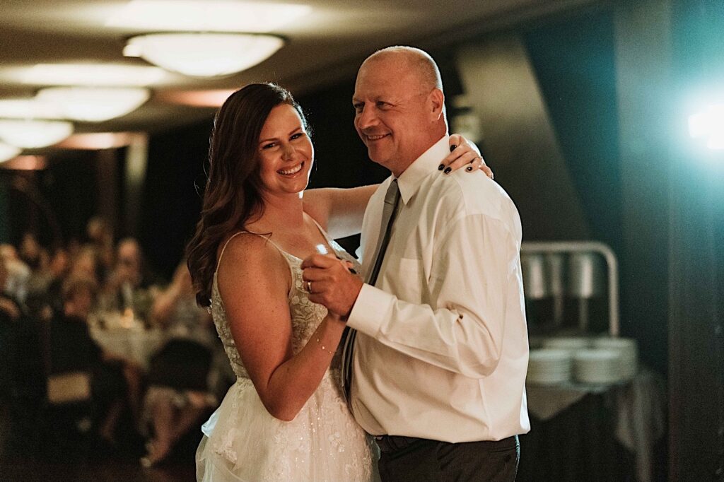 A bride and groom have their first dance at the Signature Room on the 95th floor.