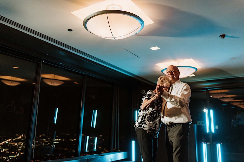 A groom and his mother share a dance during a wedding at the Signature Room on the 95th floor.