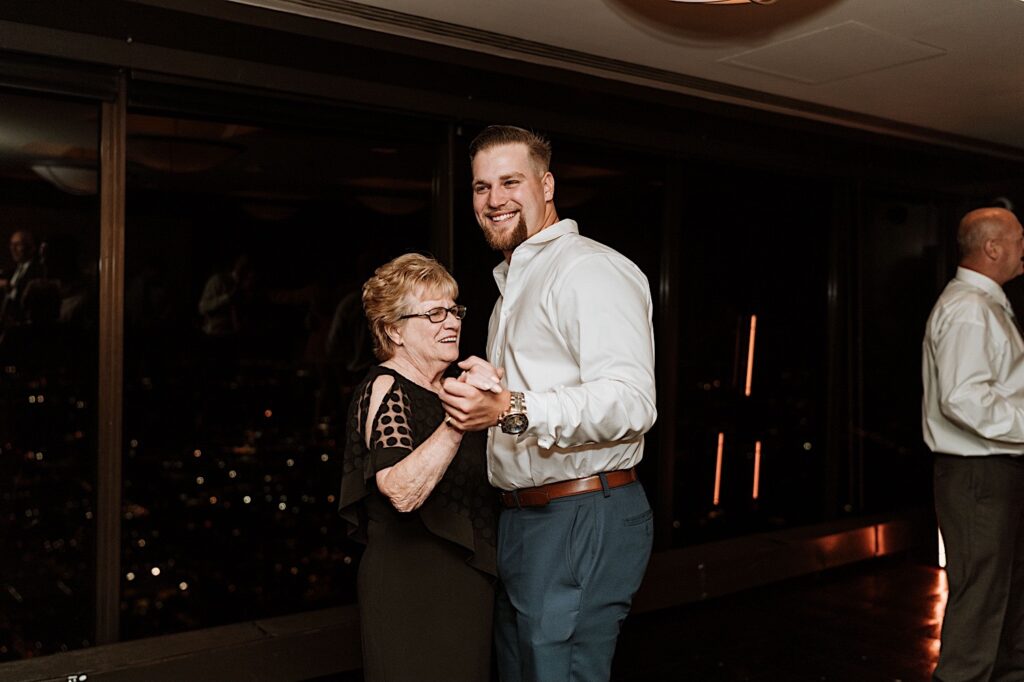 guests dance during a wedding reception thrown on the 95th floor of the John Hancock Building