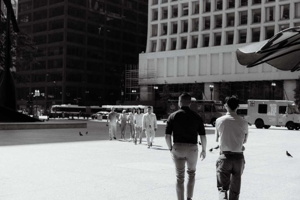 a group of people walking on a sidewalk