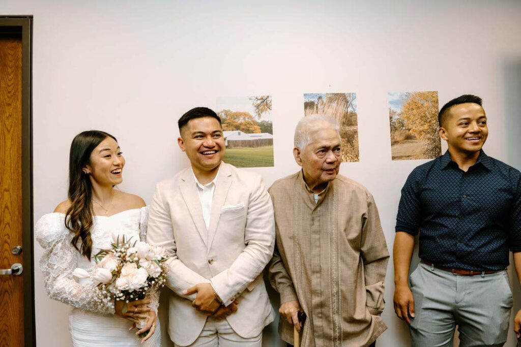 bride and groom waiting in line with grandpa and another man for their chicago city hall elopement