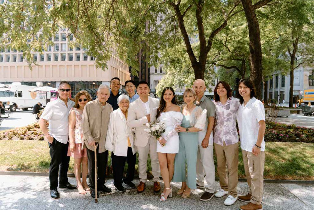 family photo with bride and groom outside - chicago city hall elopement