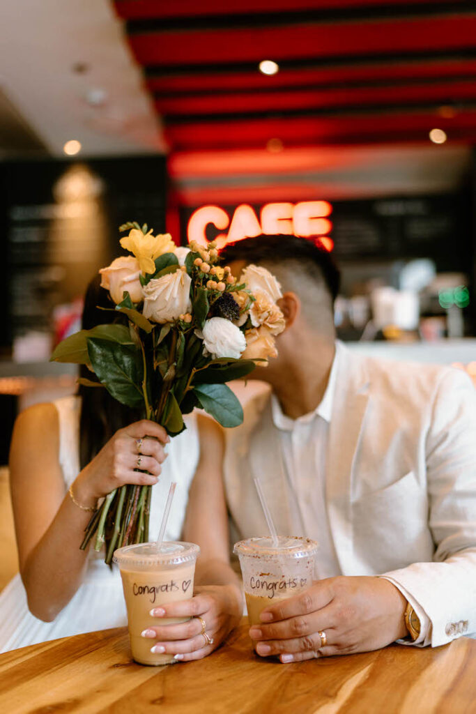 two people kissing behind a bouquet of flowers - chicago city hall elopement